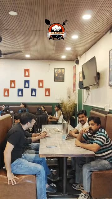 Diners in the brown booths under the green and white walls