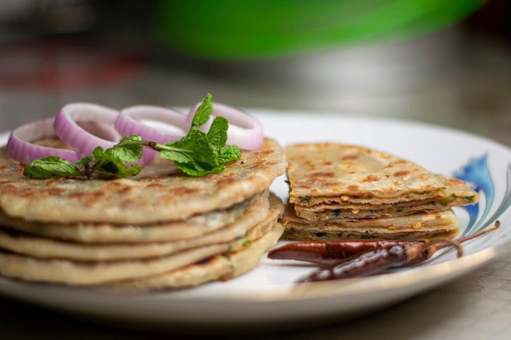 Flaky layered stuffed naan with onion and mint