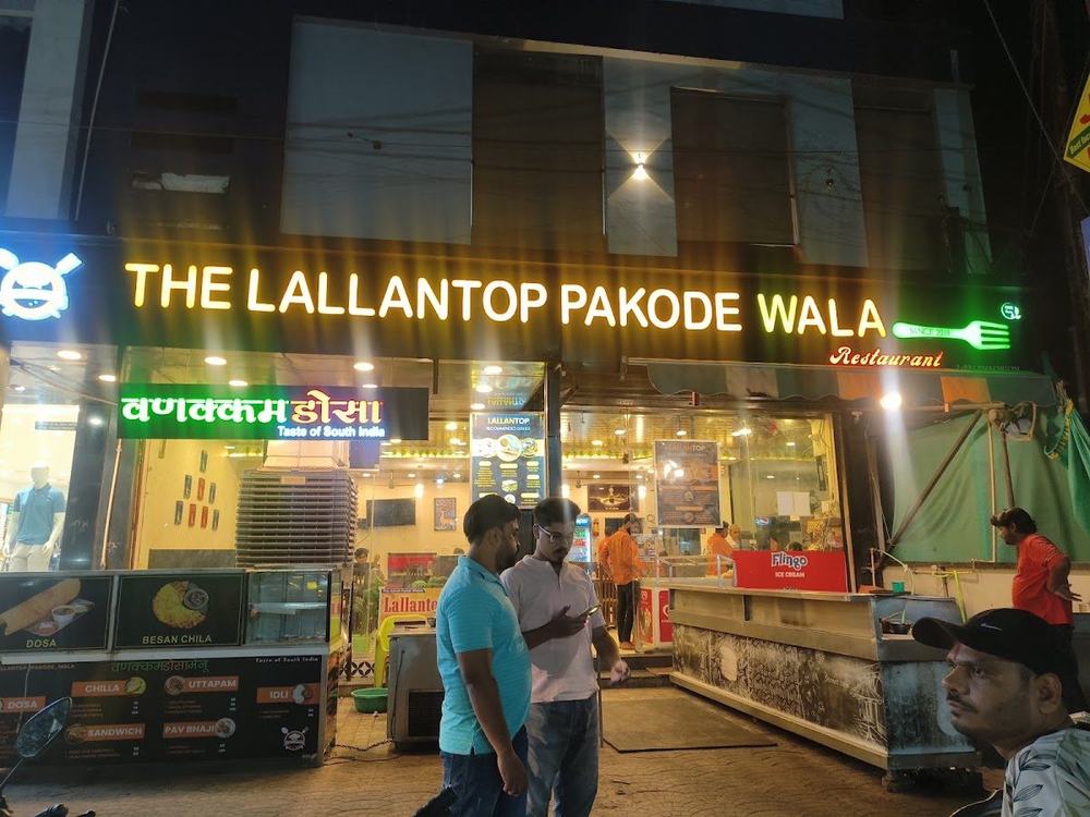 The Lallantop Pakode Wala storefront at night with its glowing yellow sign
